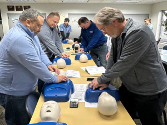 Group of people performing CPR training