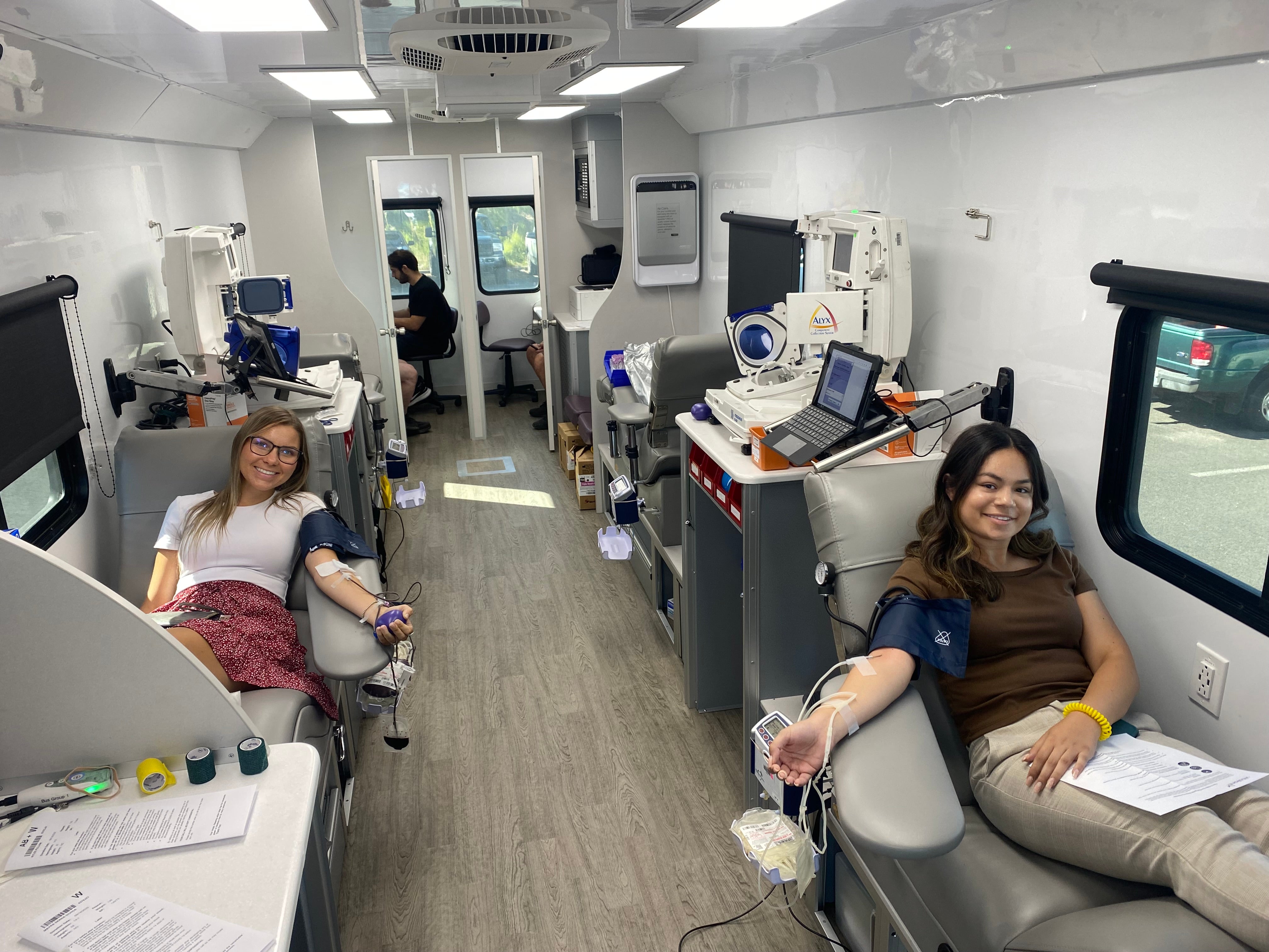 People donating blood in van
